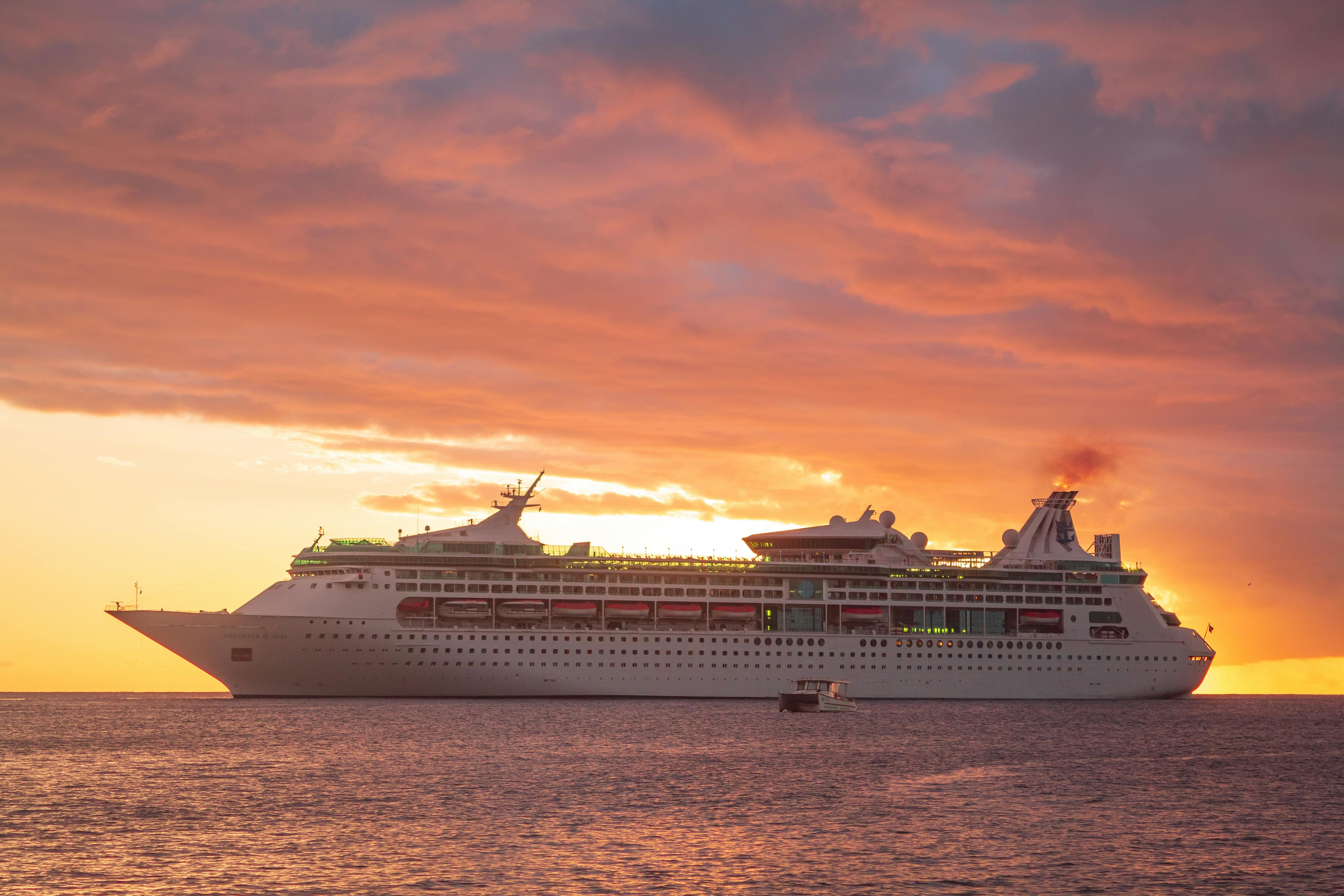 Cruise ship at golden sunset on calm water
