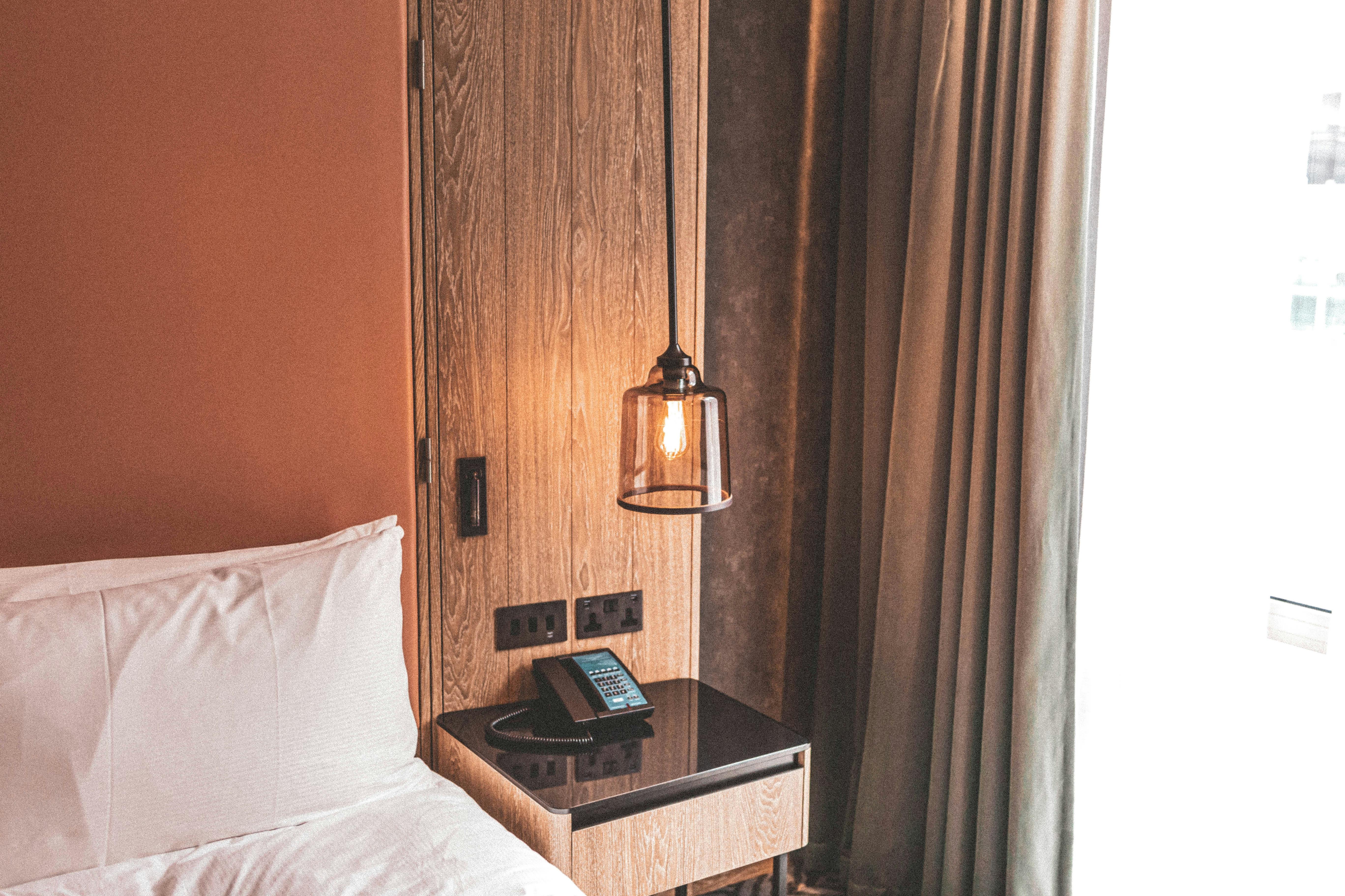 Warm hotel room with pendant lamp